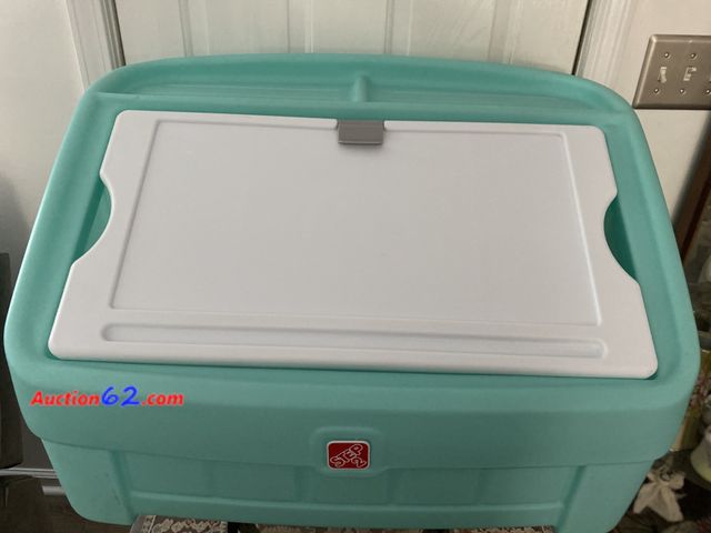 Lot 44-2000k - Gently used Step 2 blue  19” H X  30 1/2” W toy box. Has a clip to hold paper for coloring a picture. Lid is removable. See photos. Used See...