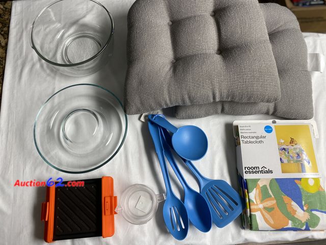 Lot 44-2033o - New. Two gray chair or stool cushions with rubber non slip backing. New Room Essentials rectangle tablecloth. Measures 60” X 104”. Seats 8 t...