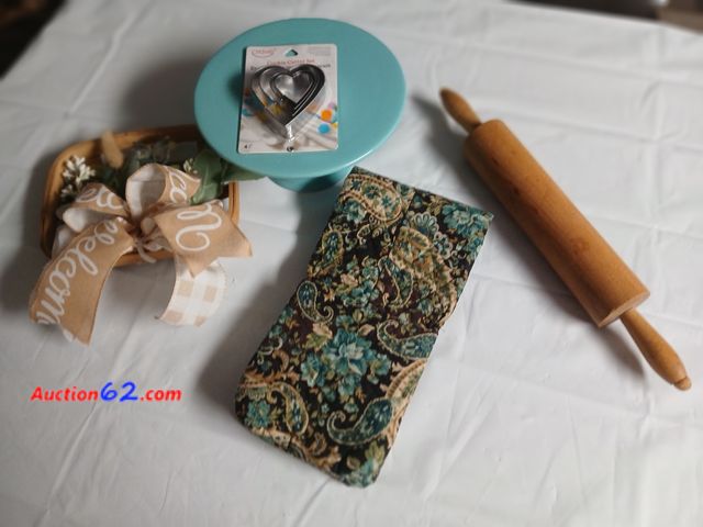 Lot 44-2128g - New without tag pioneer woman cake dish 9" wide, new cookie cutters, new handmade oven mitt, one new 6" x 9" green and  white wall hanger an...