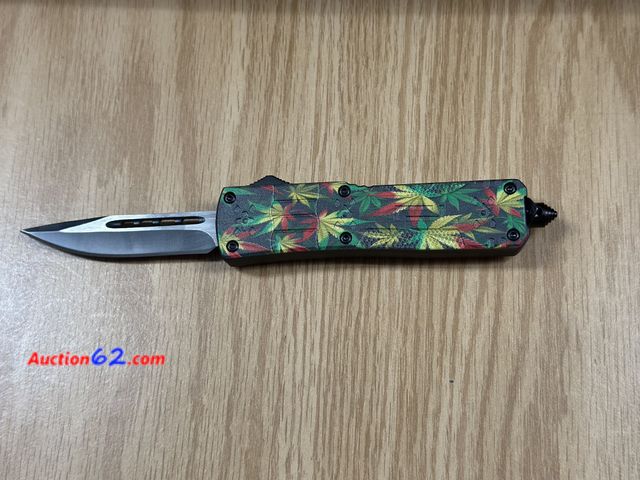Lot 44-6110o - Decorative print out the front knife, comes with glass breaker and nylon belt carrying case. New. It’s heavier See All Photo's Tested & Work...