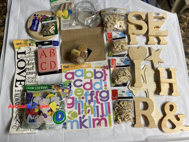Lot 44-2101w - New. Mix lot of craft merchandise. Contains wood letters, plaque, cross. Set of 5 natural sponges. 48 pc stencils. 3 laminated burlap sheets...