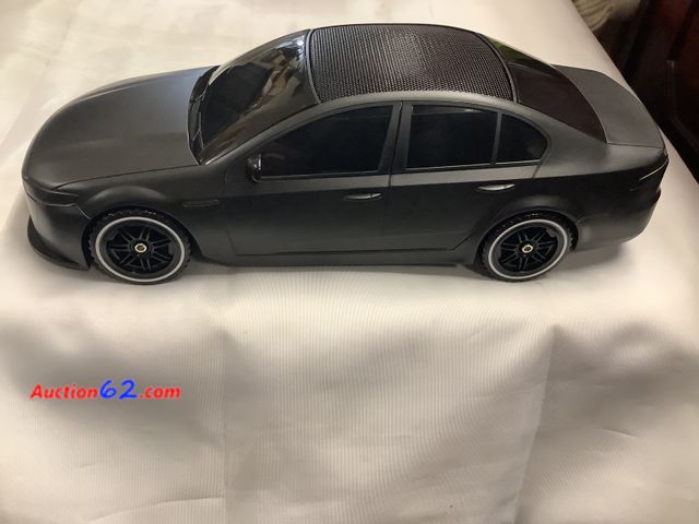 Lot 44-6017e - Bluetooth speaker car shaped. From gadgets and more. Solar rechargeable, 8W built in microphone 1200 MAH BATTERY. USB charger See All Photo'...