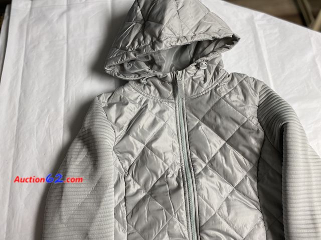 Lot 44-2102b - New with tags. Size ladies medium 8-10 jacket. Light gray with hood. Retails for 21.98. See photos. Appears New, A basic inspection has been...