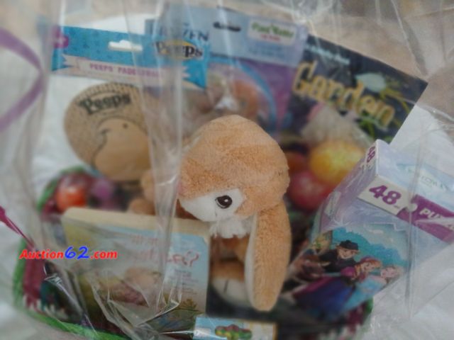 Lot 44-2128j - One girls Easter basket. Includes the  following items.  One new 48 piece frozen puzzle.  One new 8 packs of eggs.  One Fairy Garden colorin...