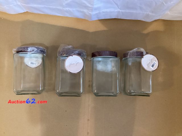 Lot 44-7710i - Lot of (4) glass storage jars with tin lids.  Appears New, A basic inspection has been given to this item. Sold AS-IS. See All Photo's