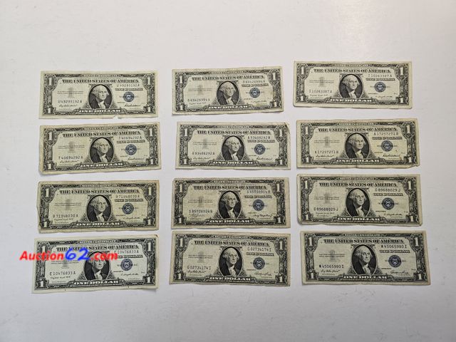 Lot 44-8332u - TWELVE (12) CIRCULATED $1 SILVER CERTIFICATES. MIX OF 1935 AND 1957 SERIES. THEY COME IN A PROTECTIVE TOPLOADER.-NT