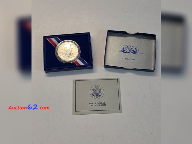 Lot 44-8319e - 1986 ELLIS ISLAND SILVER DOLLAR! SILVER IS OVER $114 AN OUNCE!!! COMES WITH COA IN THE ORIGINAL US MINT BOX.-NT