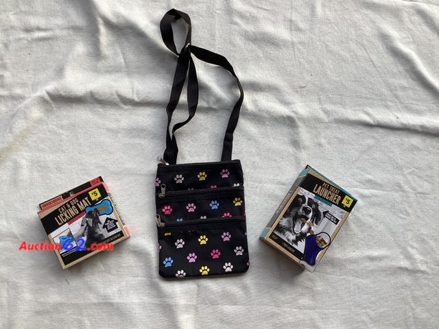 Lot 44-7891P - Lot of (3) pet themed accessories. (1) pet treat launcher, (1) pet licking mat, (1) cross body paw pad bag.  Appears New, A basic inspection...