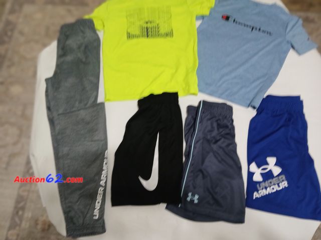 Lot 44-2119j - New (tag removed) size 7 Under Armour boys sweatpants.  One new without tag royal blue size 7 Under Armour shorts.  One gently used Under Ar...