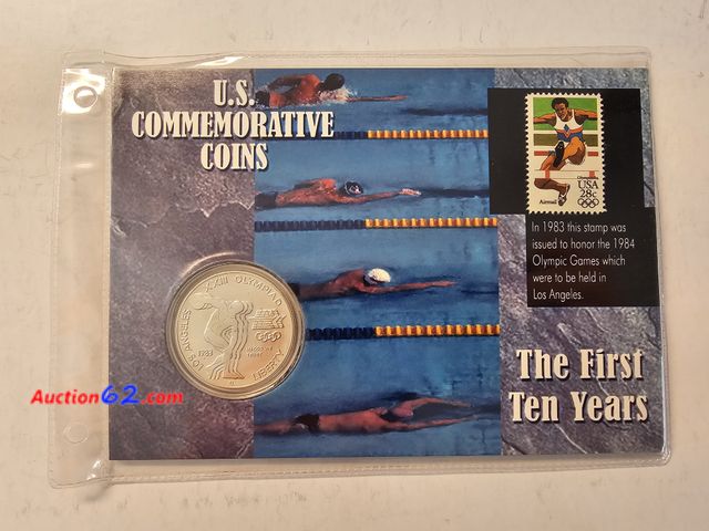 Lot 44-8355u - 1983P BRILLIANT UNCIRCULATED 90% SILVER OLYMPIC DOLLAR WITH 28¢ 1984 OLYMPIC GAMES STAMP IN A COLLECTOR PANEL.-NT