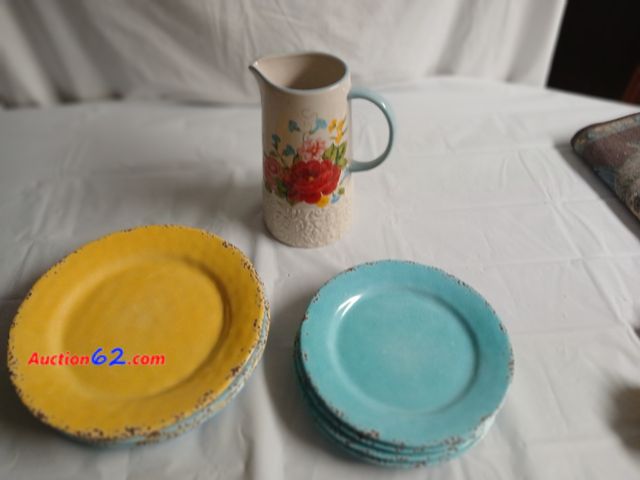 Lot 44-2126g - New with tag on bottom 9 1/2" pioneer woman pitcher, 4 gently used plates and saucers.  See photos. Appears New, A basic inspection has been...