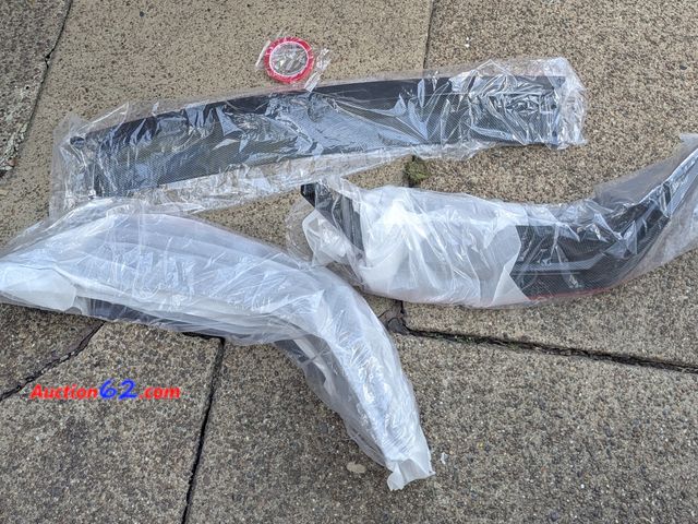 Lot 44-3076g - WheelX Front Bumper - Carbon Fiber Pattern - Ecommerce Return - See Pictures E-Commerce Return, A basic inspection has been given to this it...