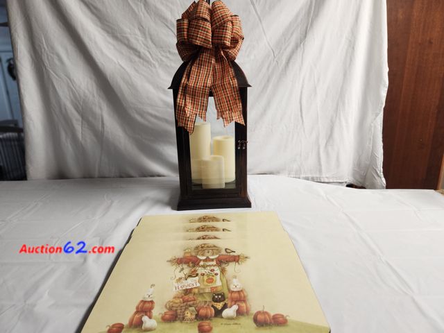 Lot 44-2112g - 1 approx 25 in H x 9 1/2 wide lantern dark in color with brushed bronze. 3 cream candles. Works has batteries with fall bow. 4 fall scarecro...