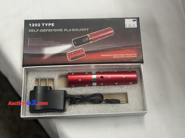 Lot 44-6147o - Type 1202 self defense flashlight and taser rechargeable. Opened for photo. Pre-priced $20 from store closing. See All Photo's Tested & Work...