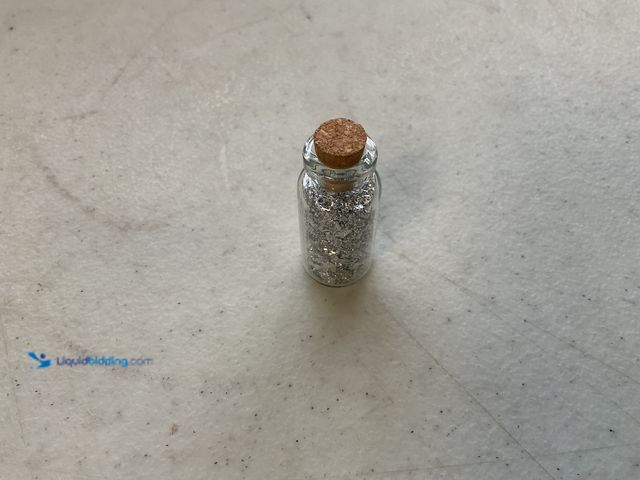Lot 49-1804566 - ONE INCH GLASS VILE OF PURE SILVER FLAKES.