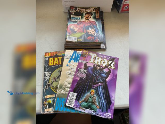 Lot 49-5341552 - LOT OF 20 COLLECTIBLE COMIC BOOKS FROM DC, MARVEL AND MORE INCLUDING THOR, AVENGERS, BATMAN AND MORE