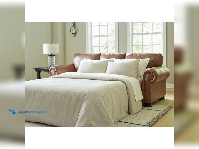Lot 49-5543646 - Signature DESIGN BY ASHLEY
Carianna 101 in Brown Leather Match Queen Size Sofa Bed. Model # 5760439...