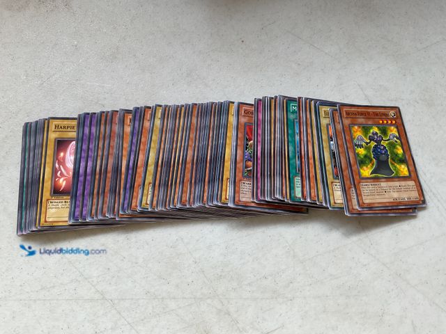 Lot 49-1830618 - COLLECTIBLE AWESOME STACK OF 100+ YU-GI-OH COLLECTIBLE TRADING CARDS FROM VARIOUS YEARS AND TYPES LO...