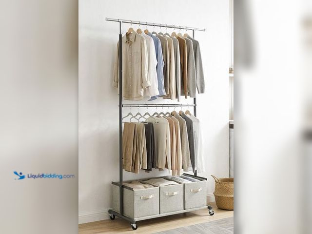Lot 49-2026338 - Better Homes & Gardens 2-Tier Metal Rolling Garment Rack with 3-Bin Organizer, Gray. Model # 9016010...