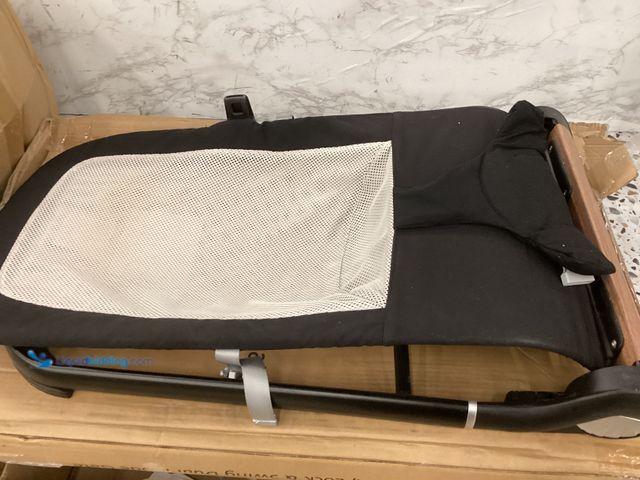 Lot 49-5406657 - Baby Bouncing sleeper, Black Includes Star Attachments, Used, Scuffs/scratches, No factory picture.