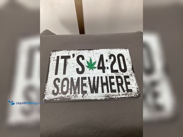 Lot 49-911506 - Graphic Sign featuring a cannabis leaf and the phrase it’s 4:20 somewhere. Comes pre-drilled for eas...