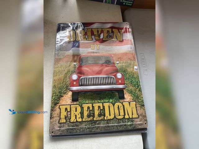 Lot 49-1977474 - Other BRAND NEW METAL COLLECTOR SIGN “DRIVEN BY FREEDOM” MEASURES APPROXIMATELY 12 INCH BY 16 INCH