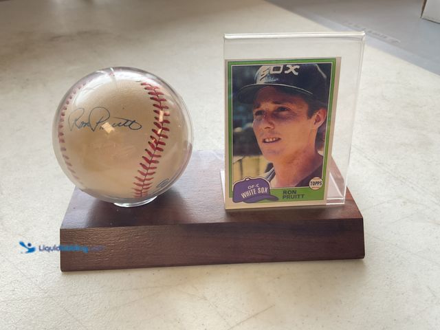 Lot 49-1804540 - RON PRUITT WOOD BASE HOLDER WITH AUTOGRAPHED BALL AND BASEBALL CARD
