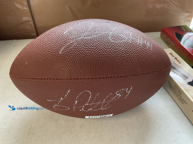 Lot 49-1830627 - COLLECTIBLE NICE WILSON FOOTBALL AUTOGRAPHED BY NFL LEGENDS BRANDON PETTIGREW AND JAHVID BEST #COINS...