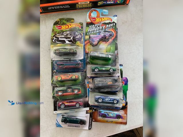 Lot 49-1505509 - COLLECTIBLE LOT OF 12 HOT WHEELS 1/64 SCALE DIECAST CARS IN ORIGINAL PACKAGES VARIOUS MAKES AND MODE...
