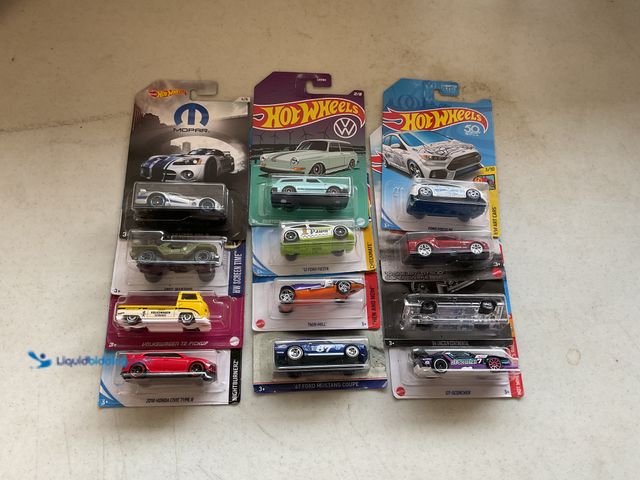 Lot 49-5341523 - LOT OF 12 NEW HOT WHEELS 1/64 SCALE DIECAST CARS IN ORIGINAL PACKAGES VARIOUS MAKES AND MODELS