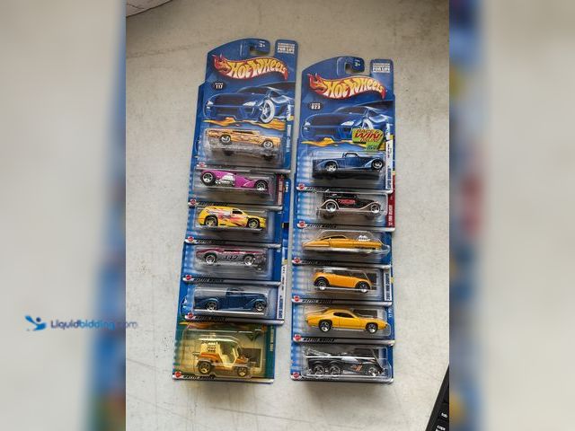 Lot 49-1830738 - COLLECTIBLE LOT OF 12 HOT WHEELS 1/64 SCALE DIECAST CARS IN ORIGINAL PACKAGES VARIOUS MAKES AND MODE...