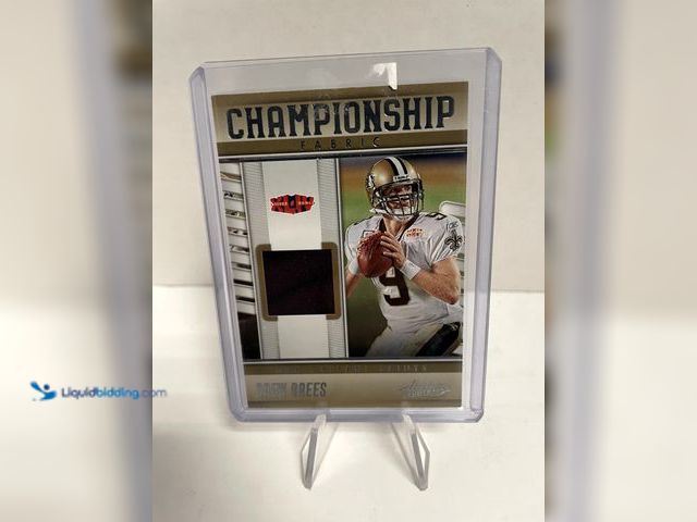 Lot 49-910511 - 2023 Panini Absolute Football Drew Brees Championship Fabric Relic Card #CF-3 Add a premium memorabi...