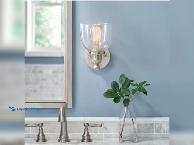 Lot 49-5436889 - Home Decorators Collection Evelyn 6 in. 1-Light Brushed Nickel Industrial Wall Sconce with Clear Gla...