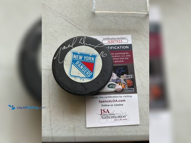 Lot 49-1801467 - NEW YORK RANGERS HALL OF FAMER MARCEL DIONNE AUTOGRAPHED HOCKEY PUCK.