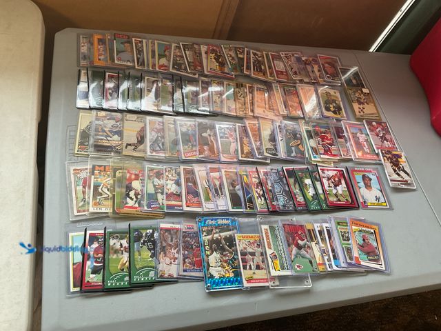 Lot 49-2009042 - Other TABLE LOT OF BETTER SPORTS CARDS IN HARD PLASTIC HOLDERS VARIOUS TYPES AND YEARS LOADED WITH S...