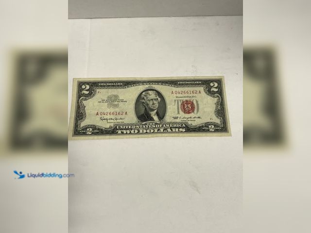 Lot 49-910570 - Series 1963 $2 United States Note featuring the distinctive red Treasury seal and serial numbers. Th...