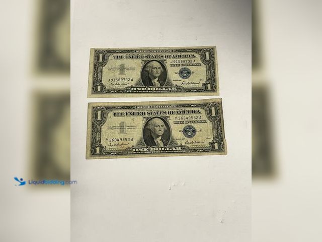 Lot 49-910568 - Lot of (2) Series 1957 $1 Silver Certificates featuring the classic blue Treasury seal and serial nu...