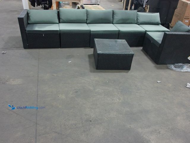 Lot 49-2022617 - (7-Piece) Woven Outdoor Patio Furniture Set, Includes glass-topped coffee table, four armless seats,...