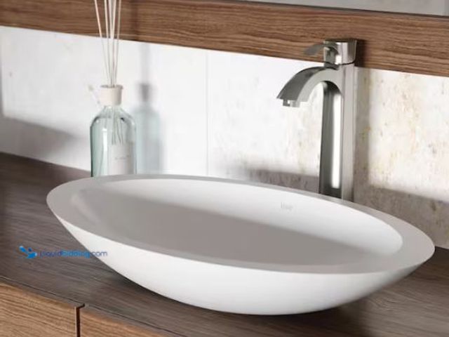Lot 49-1565976 - VIGO Wisteria Modern White Matte Stone 23 in. L x 14 in. W x 4 in. H Oval Vessel Bathroom Sink, Mode...