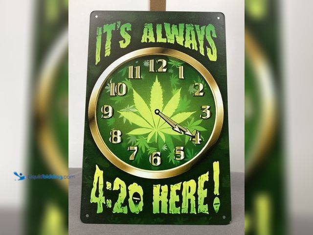 Lot 49-910808 - Decorative graphic sign featuring a cannabis leaf and the phrase “it’s always 420 here“. It measures...