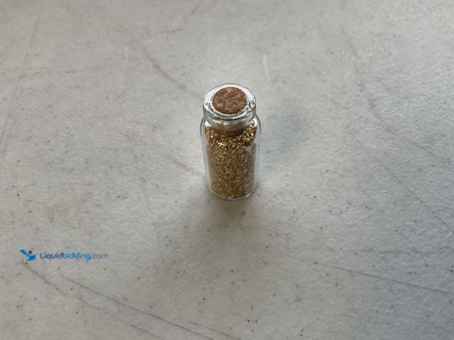 Lot 49-1804562 - ONE INCH GLASS VILE OF PURE 24KGOLD FLAKES.