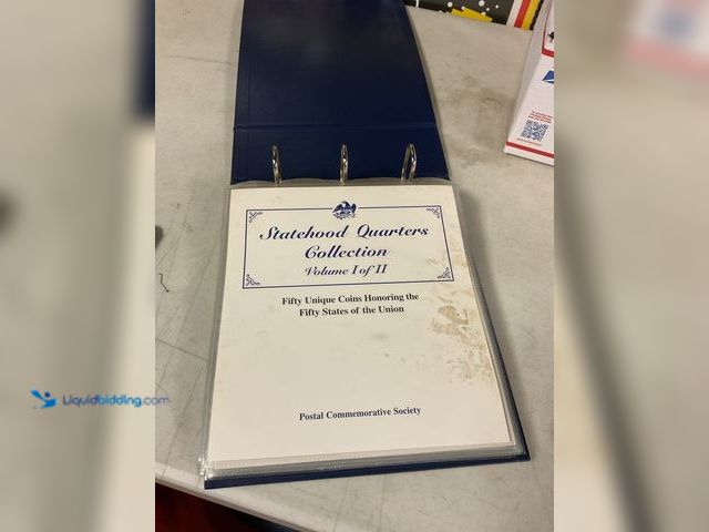 Lot 49-1505199 - POSTAL COMMEMORATIVE SOCIETY STATEHOOD QUARTERS COLLECTION VOLUME I OF II BINDER WITH 5 COIN AND STA...