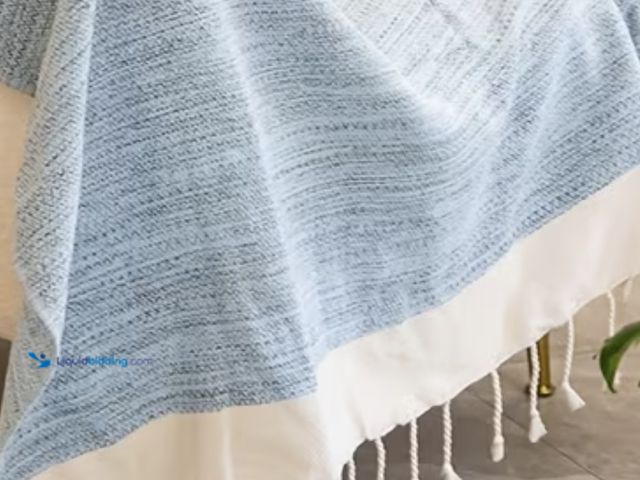 Lot 49-1975269 - Lightweight 100% Cotton Throw Blanket. Sky blue with tassels, extra long 70”x50”. New unused in orig...