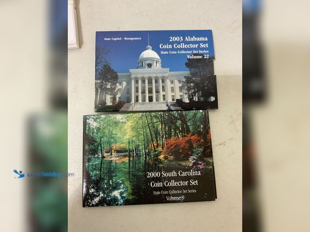 Lot 49-3709166 - LOT OF 2 STATE COIN COLLECTOR SETS SERIES QUARTERS INCLUDING 2003 ALABAMA AND 2000 SOUTH CAROLINA EA...