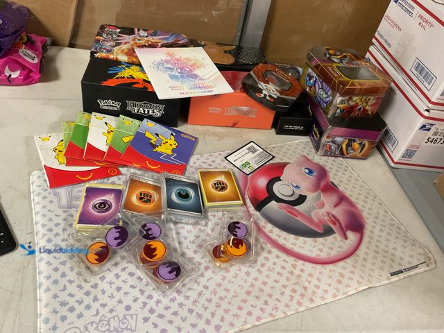 Lot 49-5467341 - Other TABLE LOT OF POEMON COLLECTIBLES AND MEMORABILIA INCLUDING TINS, BOXES (ALL EMPTY), MAT, CARDS...
