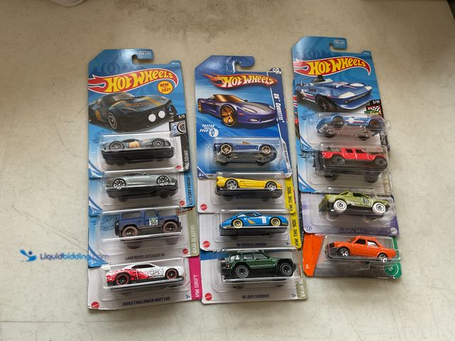 Lot 49-5350256 - LOT OF 12 HOT WHEELS 1/64 SCALE DIECAST CARS IN ORIGINAL PACKAGES VARIOUS MAKES AND MODELS