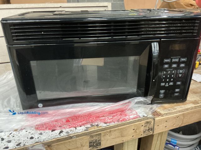 Lot 49-5489157 - 1.7 CU.FT. GE Microwave. Black. Used with no plate or ring. Tested and works. Not the same as the bo...