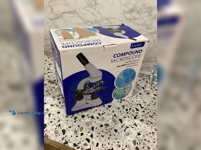 Lot 49-5460902 - Esako Compound Microscope Item is used with bag, attachments, powers on.