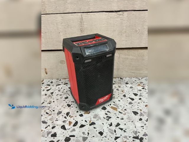 Lot 49-5489088 - Milwaukee M12 Radio + Charger. Used and dirty. NO battery or attachments.