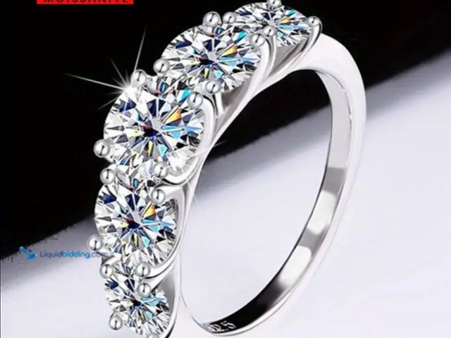 Lot 49-1817536 - 3.6 Carat Moissanite S925
Silver Ring, 5 Round Glossy Center Moissanite. Size 9 new unused.